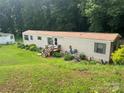 Well-maintained single-story home with a cozy front porch and lush green lawn at 2165 Peanuts Ln, Newton, NC 28658