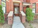 Inviting front entrance with brick accents and landscaped details at 2810 Selwyn Ave # 104, Charlotte, NC 28209