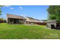 Large backyard featuring a covered deck, green lawn and brown wood fence at 286 Mallard Head Dr, Rock Hill, SC 29732