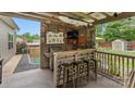 Outdoor bar featuring a grill, granite countertop, seating, and TV at 286 Mallard Head Dr, Rock Hill, SC 29732