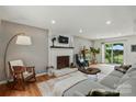 Cozy living room featuring a fireplace, hardwood floors, and comfortable seating at 314 Sunnywood Ln, Charlotte, NC 28270