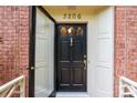Elegant black front door with glass accents and brass hardware at 3209 Sedgefield Rd, Statesville, NC 28625