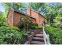 Brick home featuring brick steps leading to the side of the home and lush landscaping at 3209 Sedgefield Rd, Statesville, NC 28625
