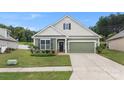 Charming single-Gathering home features green siding, a matching garage door, and well-maintained landscaping at 3735 Norman View Dr, Sherrills Ford, NC 28673