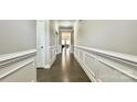Long hallway with hardwood floors and detailed trim work leads to the home's living areas at 3735 Norman View Dr, Sherrills Ford, NC 28673