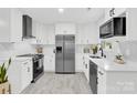 Modern kitchen with sleek white cabinets, stainless steel appliances, and elegant countertops at 4108 Mellon Rd, Matthews, NC 28104
