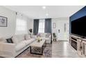 Bright living room featuring neutral colors, modern decor, and lots of natural light streaming through the windows at 4108 Mellon Rd, Matthews, NC 28104