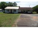 Charming single-Gathering home with a metal roof, carport, and mature trees at 5004 King Wilkinson Rd, Denver, NC 28037