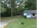 Expansive front yard with mature trees offering shade and privacy to the home at 555 Ridge Ave, Mooresville, NC 28115