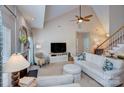 Bright living room with vaulted ceilings, a cozy fireplace, and a comfortable seating area at 5748 Timbertop Ln, Charlotte, NC 28215