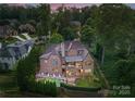 Bird's eye view of a large brick home showcasing the pool and surrounding landscape at 5915 Vidal Ln, Charlotte, NC 28226