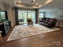 Spacious living room features hardwood floors, a large window, and recessed lighting at 7057 Kingfisher Way, Belmont, NC 28012