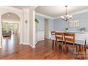 Elegant dining area with hardwood flooring, wainscoting, and a view into the adjacent living room at 8829 Keller Ct, Huntersville, NC 28078
