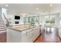 A large island kitchen boasting stainless steel appliances, granite countertops, and views to the Gathering room at 8829 Keller Ct, Huntersville, NC 28078