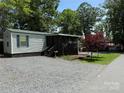 Inviting home featuring a cozy screened porch, lush greenery, and ample space for outdoor enjoyment at 102 Papoose Ct # D117, Mount Gilead, NC 27306
