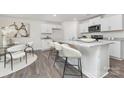The kitchen features an eat-in island with white cabinets, granite countertops and stainless appliances at 1053 Horizon Ln, Chester, SC 29706