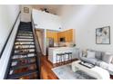 Bright living room with stainless steel appliances, modern cabinets, and a loft staircase at 115 E Park Ave # 428, Charlotte, NC 28203