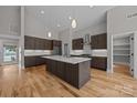 Island kitchen featuring wooden cabinets, a white countertop island, and pendant lighting fixtures at 1207 Lakedell Dr, Charlotte, NC 28215