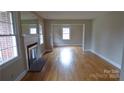 An empty living room featuring hardwood floors and a fireplace with a decorative mantel at 1245 Paddock Cir, Charlotte, NC 28209