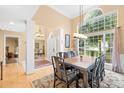 Bright dining room featuring a large window, hardwood floors, and elegant chandelier at 125 Canopy Ct, Mooresville, NC 28115