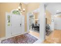 Bright foyer with white pillars, chandelier, and view of the dining room at 125 Canopy Ct, Mooresville, NC 28115