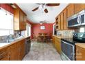 Galley kitchen featuring warm wood cabinets and stainless steel appliances, connected to an eat-in dining area at 1371 Hawks Nest Rd, York, SC 29745