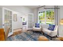 Cozy living area featuring hardwood floors, bright window views, and french doors to an adjacent room at 138 Rustling Waters Dr, Mooresville, NC 28117
