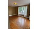 Bright living room featuring hardwood floors and multiple windows at 1510 Stoker Ter, Albemarle, NC 28001