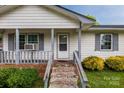 Inviting front porch with decorative rails, colorful bushes, and well-kept front yard at 1613 Hamilton St, Charlotte, NC 28206