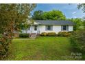 Quaint single-story home with a cozy front porch and lush green lawn at 1613 Hamilton St, Charlotte, NC 28206
