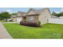 Well-kept home showcasing stone accents, a manicured lawn, and an attached two-car garage at 2021 Chantilly Ln, Salisbury, NC 28146