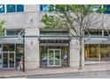 Modern building entrance features a glass door and transom with awning, street lamp, and sidewalk at 210 N Church St # 2910, Charlotte, NC 28202