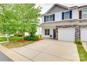View of townhome with tidy landscaping, hardscaped driveway, and classic curb appeal at 2169 Shady Pond Dr, Clover, SC 29710