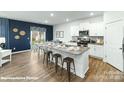 Modern kitchen featuring white cabinets, granite countertops, stainless steel appliances, and an island with barstool seating at 221 Paige Rd, Kings Mountain, NC 28086