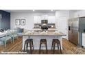 Bright kitchen with white cabinets, granite countertops, stainless steel appliances, and an island with barstool seating at 221 Paige Rd, Kings Mountain, NC 28086