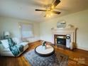 Bright living room with hardwood floors, ceiling fan, fireplace, and comfortable seating at 2357 28Th Ne St, Hickory, NC 28601