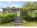 Inviting front entrance with a bright green door, brick steps, and lush landscaping at 2536 Bancroft St, Charlotte, NC 28206