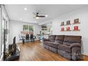 Open living room featuring hardwood floors, a ceiling fan, and ample natural light at 2536 Bancroft St, Charlotte, NC 28206
