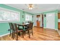 Inviting dining area with hardwood floors, large windows, and classic ceiling fan at 2601 Marldale St, Gastonia, NC 28052