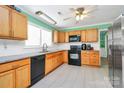 Bright kitchen with wood cabinets, tile floors, and modern appliances at 2601 Marldale St, Gastonia, NC 28052