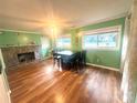 Comfortable living area with wood floors, a stone fireplace, and lots of natural light from the bright green walls at 2601 Marldale St, Gastonia, NC 28052