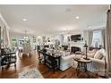 Spacious living room featuring hardwood floors, fresh white paint, fireplace, and an open layout at 2829 Holt St, Charlotte, NC 28205