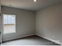 Serene bedroom featuring neutral paint, carpet, and a window at 2915 Noritake Trl # 71, Albemarle, NC 28001