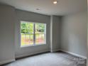 Cozy bedroom with a large window, soft carpet, and neutral paint at 2915 Noritake Trl # 71, Albemarle, NC 28001