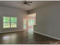 Bright living room featuring hardwood floors, neutral paint, ample natural light, and a ceiling fan at 2915 Noritake Trl # 71, Albemarle, NC 28001