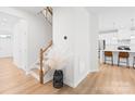 Welcoming entryway with hardwood floors, stairs to the upper level, and view to the kitchen at 3110 Streamside Dr, Davidson, NC 28036