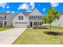 Charming two-story home boasts a well-maintained lawn, two-car garage, and classic curb appeal at 3110 Streamside Dr, Davidson, NC 28036