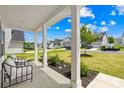 Inviting front porch offers seating and views of the landscaped front yard and neighborhood street at 3110 Streamside Dr, Davidson, NC 28036