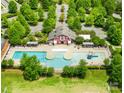 Aerial view of a community pool and clubhouse surrounded by lush green trees at 3110 Streamside Dr, Davidson, NC 28036