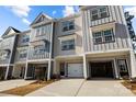 Beautiful townhome exterior showcasing a two-car garage, and a well-manicured front yard with fresh landscaping at 3124 Butler Hill Dr, Matthews, NC 28105